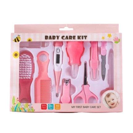 A pink baby care kit featuring thermometer, nasal inhaler, safety nail clippers, comb, and brush designed for grooming and caring for infant.