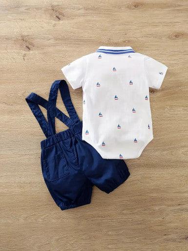 A 2-piece infant boys' outfit featuring a sailboat-themed short-sleeve shirt with a bowtie, snap bottom, and navy blue suspender shorts, perfect for a charming and stylish look.