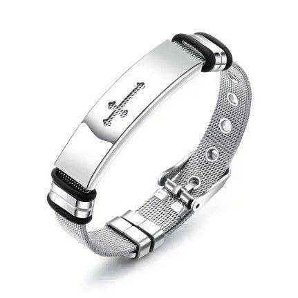 A sleek silver bracelet featuring a cross engraving on a polished metal plate. The bracelet has a mesh band with an adjustable buckle clasp, offering a modern and elegant design.