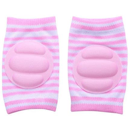 Pink and white striped baby knee pads with soft, cushioned oval padding in the center for crawling protection.