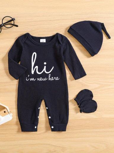 A cute baby Long Sleeve Baby Romper in Navy Blue accompanied by a matching hat and mittens, showcasing a cheerful and playful outfit displaying the text "Hi, I'm new here."