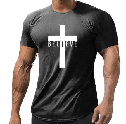 Black men's athletic T-shirt featuring a large white cross with the word "BELIEVE" integrated into the design. The shirt is fitted, showcasing a muscular build, and made from a material that appears breathable and comfortable, ideal for workouts or casual wear.