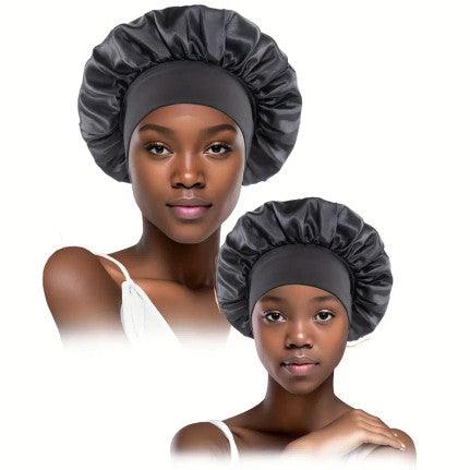 Two models wearing matching black satin bonnets, one adult and one child. The bonnets are designed to protect hair while sleeping, featuring a smooth, shiny finish and a wide elastic band for a secure and comfortable fit. The satin material helps reduce friction, preventing hair breakage and maintaining moisture.