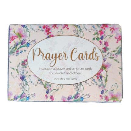 A box of prayer cards with a floral design on the packaging. The label on the front reads "Prayer Cards" in elegant script, along with a description: "Inspirational prayer and scripture cards for yourself and others. Includes 20 Cards." The colorful flowers on the box create a soft and uplifting presentation, making it a thoughtful gift or personal devotional tool.