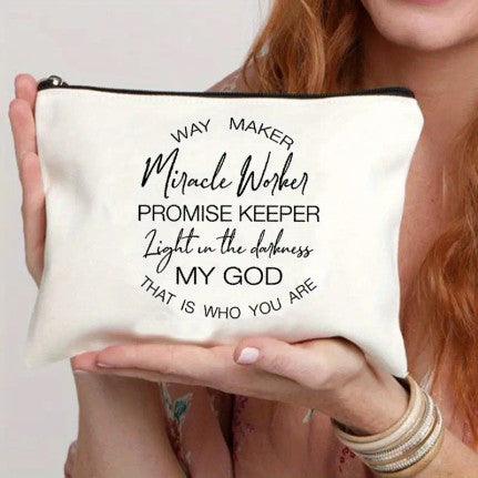 A close-up image of a white canvas pouch with black text that reads: "Way Maker, Miracle Worker, Promise Keeper, Light in the Darkness, My God, That is Who You Are." The pouch has a black zipper and is being held by a person, showcasing its size and design. The text is a popular Christian phrase, making the pouch ideal for storing small personal items or as a faith-inspired gift.