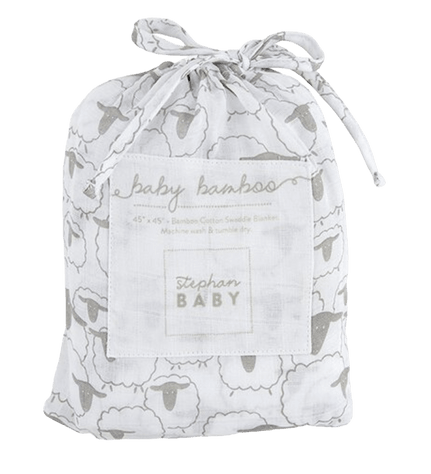 The image depicts a white drawstring bag adorned with a pattern of gray sheep. The bag features a square label on the front with the text "baby bamboo" at the top, followed by "45” x 45” • Bamboo Cotton Swaddle Blanket. Machine wash & tumble dry." The label also includes the brand name "stephan BABY" at the bottom. The drawstring at the top is tied in a bow, giving the bag a neat, gift-ready appearance, typically used for packaging and storing a baby blanket.