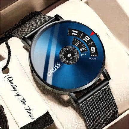 A sleek men's wristwatch featuring a metallic blue dial with a minimalist design. The watch has a unique time display with rotating dials for hours and minutes, and the brand name "ORUSS" is printed on the face. The watch is paired with a black mesh strap, adding a modern and sophisticated touch. It is presented in a gift box with a tag that reads "Quality of The Times."